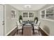 Dining room with a glass table, upholstered chairs, and a decorative rug with a modern light fixture overhead at 1805 Knox Ave, Sanford, FL 32771