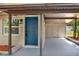 A close-up of the front entry featuring a bright blue door and convenient covered parking at 1805 Knox Ave, Sanford, FL 32771