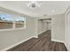 Spacious living room boasts stylish wood-look floors, neutral paint, base molding, modern lighting, and windows at 1805 Knox Ave, Sanford, FL 32771