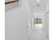 Well-lit hallway features tile flooring and a view to the backyard at 182 River Front Way, Edgewater, FL 32141