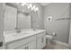 Bathroom featuring a double vanity with modern fixtures and a shower with a shower curtain at 1873 White Feather Loop, Oakland, FL 34787