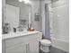Clean, well-lit bathroom with modern vanity, shower-tub combo, and neutral colors at 1873 White Feather Loop, Oakland, FL 34787