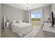 Bright bedroom featuring a large window with a view, and neutral decor at 1873 White Feather Loop, Oakland, FL 34787