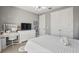 Bright bedroom featuring white furniture, a modern light fixture, and a stylish vanity area at 1873 White Feather Loop, Oakland, FL 34787