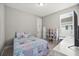 Bedroom with a colorful patchwork quilt, a small plush rug, and ample storage for toys at 1873 White Feather Loop, Oakland, FL 34787