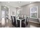 Stylish dining room with large windows and a contemporary light fixture at 1873 White Feather Loop, Oakland, FL 34787