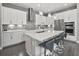 Modern kitchen with white cabinets, stainless steel appliances, and a quartz island at 1873 White Feather Loop, Oakland, FL 34787