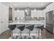 Open kitchen features white cabinets, stainless steel appliances, and a large island at 1873 White Feather Loop, Oakland, FL 34787