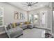 Cozy living room with a comfortable sectional sofa, accent pillows, and modern decor at 1873 White Feather Loop, Oakland, FL 34787