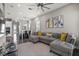 Spacious living room featuring a sectional sofa, large windows, and an open layout at 1873 White Feather Loop, Oakland, FL 34787