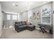 Comfortable loft area featuring a sectional sofa, modern art, and a keyboard setup near bright windows at 1873 White Feather Loop, Oakland, FL 34787