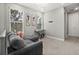 Cozy loft area with comfortable gray sofa, keyboard, and large windows at 1873 White Feather Loop, Oakland, FL 34787