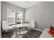 Bright home office with stylish desk and large windows, perfect for productivity at 1873 White Feather Loop, Oakland, FL 34787