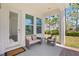 Cozy front porch seating area featuring comfortable furniture with decorative pillows and an inviting outdoor space at 1873 White Feather Loop, Oakland, FL 34787