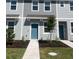 New construction townhome features light blue siding and a small front yard with new landscaping at 2081 Viewfinder St, Kissimmee, FL 34758