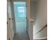 Hallway to the upper level has carpeted stairs and access to a bedroom with a window at 2081 Viewfinder St, Kissimmee, FL 34758