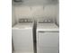 A laundry room featuring a white washer and dryer set with wire shelving at 2081 Viewfinder St, Kissimmee, FL 34758