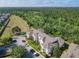 Condominiums with parking and green space in a treed area, aerial view at 2300 Silver Palm Dr # 205, Kissimmee, FL 34747