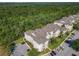 Aerial view of condominiums surrounded by lush greenery and trees at 2300 Silver Palm Dr # 205, Kissimmee, FL 34747