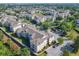 Aerial view of apartment buildings surrounded by trees, green space, and residential community at 2300 Silver Palm Dr # 205, Kissimmee, FL 34747