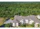 An aerial view of multiple residential buildings surrounded by lush greenery and parking lots at 2300 Silver Palm Dr # 205, Kissimmee, FL 34747
