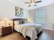Bright bedroom with a comfortable bed, stylish decor, and ample natural light from the window at 2300 Silver Palm Dr # 205, Kissimmee, FL 34747