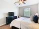 Bedroom with wood floors, ceiling fan, and black dresser at 2300 Silver Palm Dr # 205, Kissimmee, FL 34747