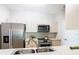 Kitchen with stainless steel appliances, white cabinets, and light countertops at 2300 Silver Palm Dr # 205, Kissimmee, FL 34747