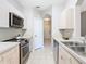 Bright kitchen features stainless steel appliances and tile floors at 2300 Silver Palm Dr # 205, Kissimmee, FL 34747