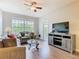 Cozy living room features a ceiling fan, large windows and balcony access at 2300 Silver Palm Dr # 205, Kissimmee, FL 34747