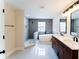Modern bathroom with double vanity, freestanding tub, and separate walk-in shower at 2308 Holly Pine Cir, Orlando, FL 32820