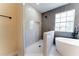 Modern bathroom featuring a walk-in shower and a freestanding bathtub at 2308 Holly Pine Cir, Orlando, FL 32820