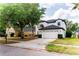 Charming two-story home with a well-manicured lawn and a spacious two-car garage at 2308 Holly Pine Cir, Orlando, FL 32820