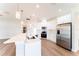 Bright, modern kitchen with an island, stainless steel appliances, and wood-look flooring at 2308 Holly Pine Cir, Orlando, FL 32820