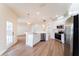 Open-concept kitchen featuring stainless steel appliances, white cabinetry, and pendant lighting at 2308 Holly Pine Cir, Orlando, FL 32820