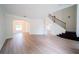 Spacious living room with hardwood floors, a staircase, and arched doorways at 2308 Holly Pine Cir, Orlando, FL 32820