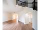 Spacious living room with hardwood floors, a staircase, and arched doorways at 2308 Holly Pine Cir, Orlando, FL 32820