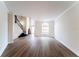 Bright living room with wood floors, large windows, and elegant staircase at 2308 Holly Pine Cir, Orlando, FL 32820