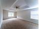 Bright main bedroom with ample natural light from windows and neutral carpeting at 2308 Holly Pine Cir, Orlando, FL 32820