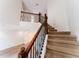 Carpeted staircase featuring wooden handrails and decorative iron balusters at 2308 Holly Pine Cir, Orlando, FL 32820