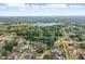 Expansive aerial view of a lakeside community featuring lush greenery and single Gathering homes, many with pools at 2423 Auld Scot Blvd, Ocoee, FL 34761