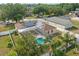 Aerial view of a fenced property featuring a pool, shed, and solar panels on the roof at 2423 Auld Scot Blvd, Ocoee, FL 34761