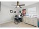 Comfortable bedroom with neutral walls, ceiling fan, and workspace with storage furniture at 2423 Auld Scot Blvd, Ocoee, FL 34761