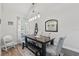 Bright dining room featuring modern chandelier, wood table, bench seating, and decor at 2423 Auld Scot Blvd, Ocoee, FL 34761