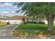 Charming single-story home featuring a well-manicured lawn and attached two-car garage at 2423 Auld Scot Blvd, Ocoee, FL 34761