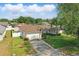 Well-manicured front lawn and driveway leading to an attached garage at 2423 Auld Scot Blvd, Ocoee, FL 34761