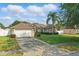 Inviting single-story home with a lush front yard, a driveway, and an attached garage at 2423 Auld Scot Blvd, Ocoee, FL 34761