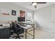 Home office with black and white desk, desk chair, printer, and window with blinds at 2423 Auld Scot Blvd, Ocoee, FL 34761