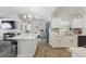Spacious, open kitchen with a center island, light wood floors, and white cabinetry at 2423 Auld Scot Blvd, Ocoee, FL 34761