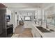 Bright, open kitchen flowing to living room, with stainless appliances and white cabinetry at 2423 Auld Scot Blvd, Ocoee, FL 34761